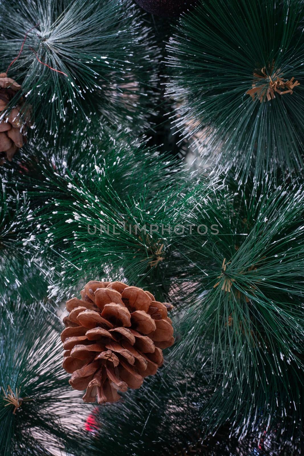 Beautiful background with bokeh effect and snowflakes for a Christmas greeting card with decorations on the branches of the Christmas tree