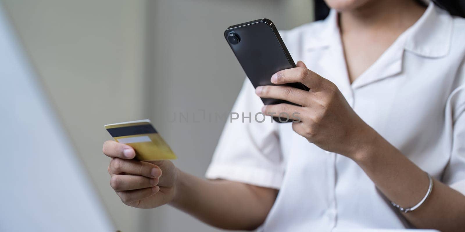 Woman on desk with smartphone, credit card and ecommerce payment for online shopping at home. Happy female customer, digital bank app and sale on store website with internet banking by nateemee