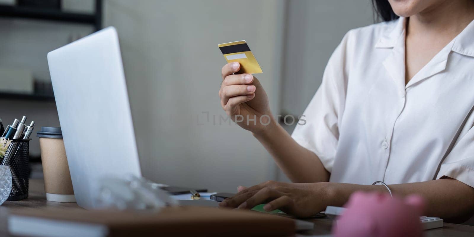 Woman on desk with laptop, credit card and ecommerce payment for online shopping at home. Happy female customer, digital bank app and sale on store website with internet banking by nateemee