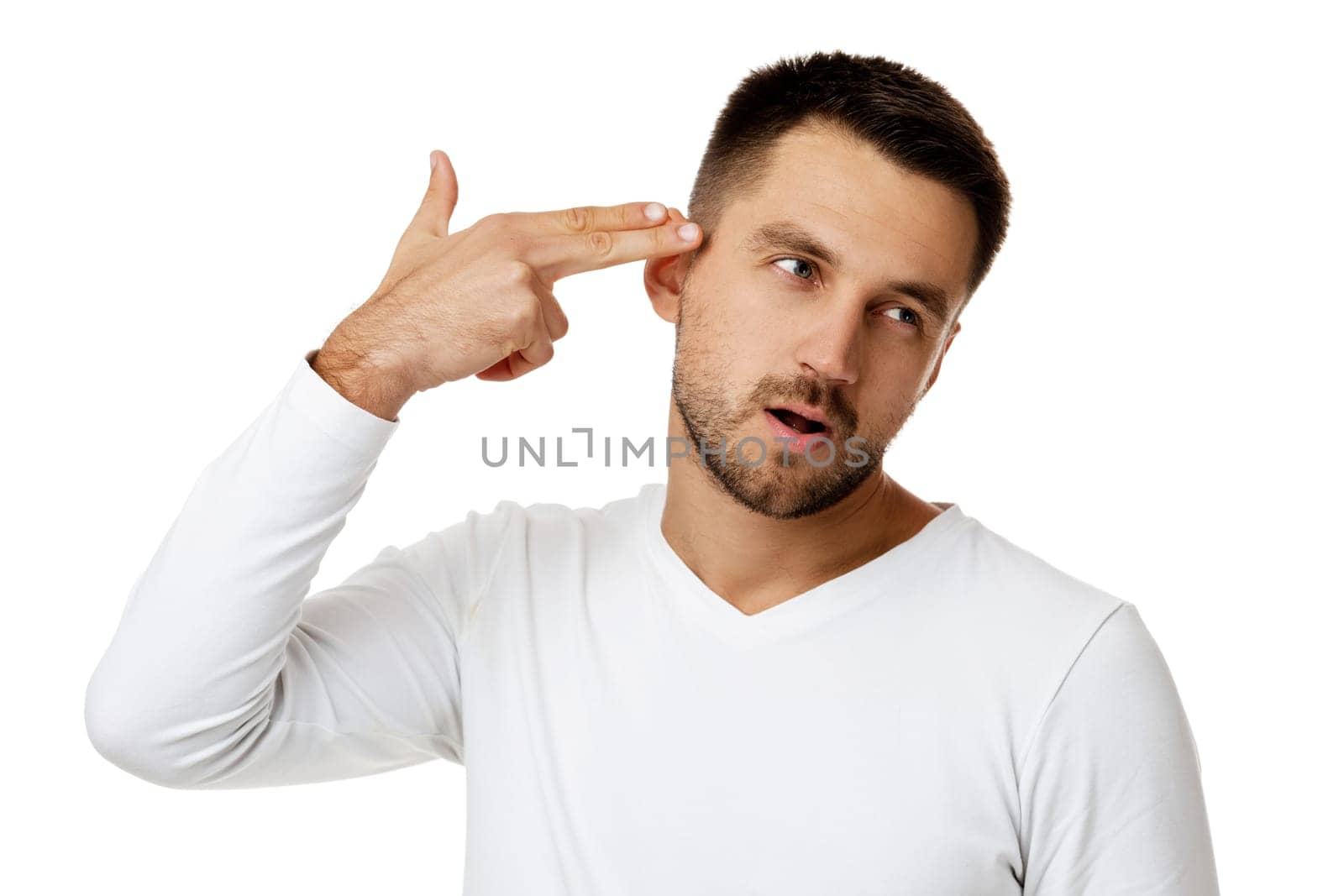 bearded man in casual white shirt shooting in temple with hand isolated on white background.