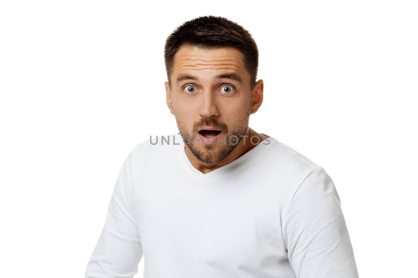 Portrait of young surprised handsome bearded man with shocked facial expression on white background. it's unbelievable