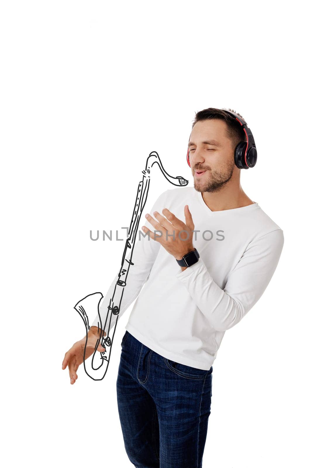 handsome young man in headphones listening to music and playing an imaginary saxophone isolated on white background.
