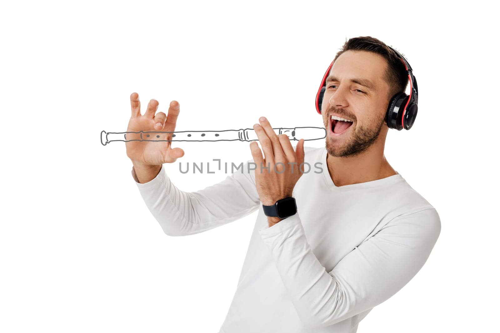 handsome young man in headphones listening to music and playing an imaginary flute isolated on white background.
