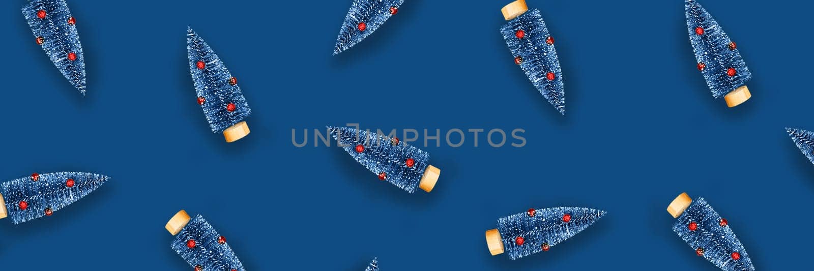 Christmas and New year classic blue decorative background with christmas trees. Flat lay, top view, copy space.