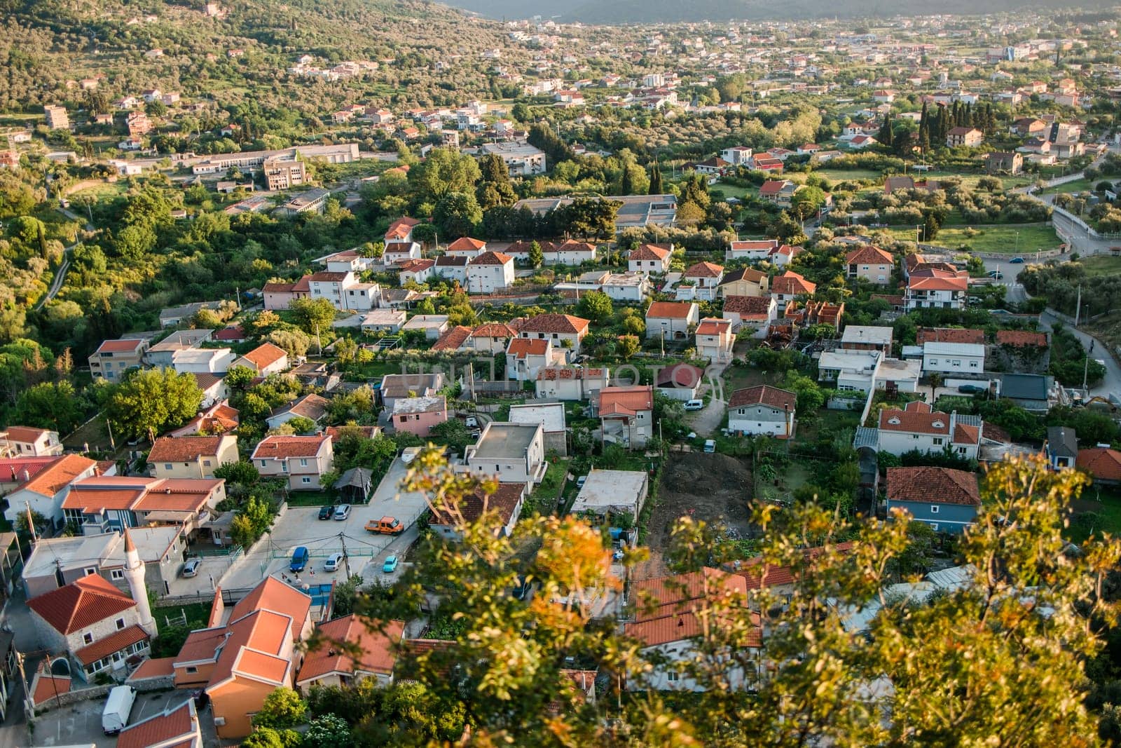 Mosque and panoramic cityscape of town Bar in Montenegro with road and houses, aerial view by Satura86