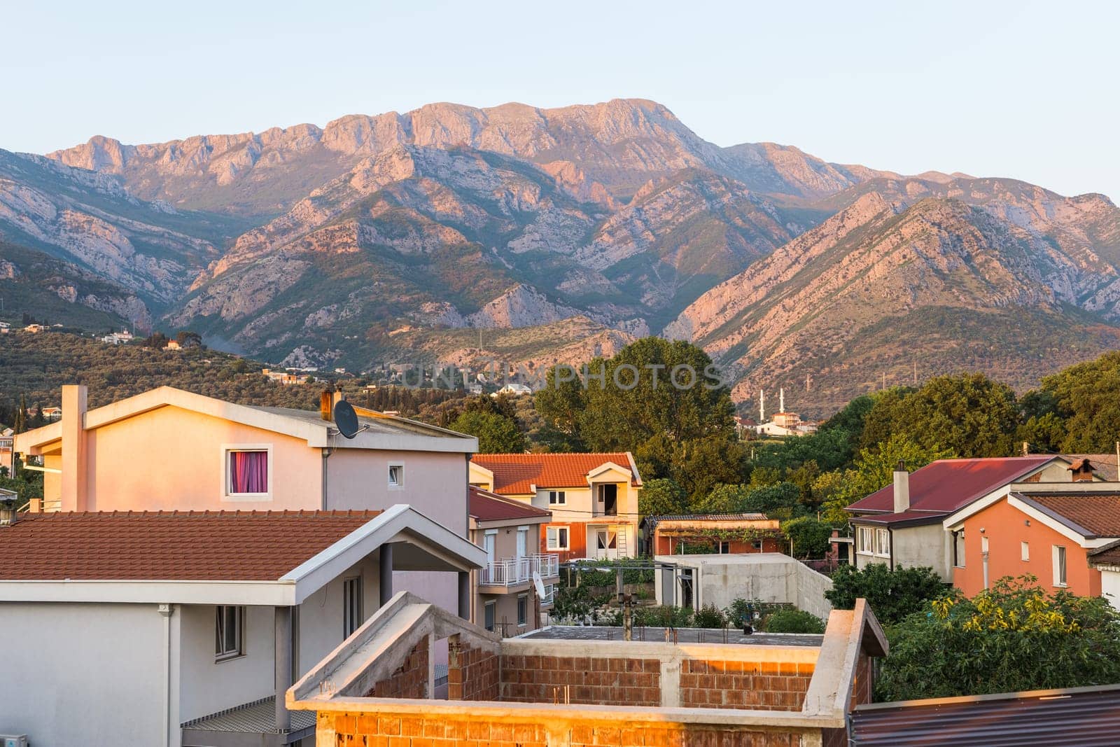 View of a small village with mountain houses on the mountain crest in Bar city Montenegro. Sunset by Satura86