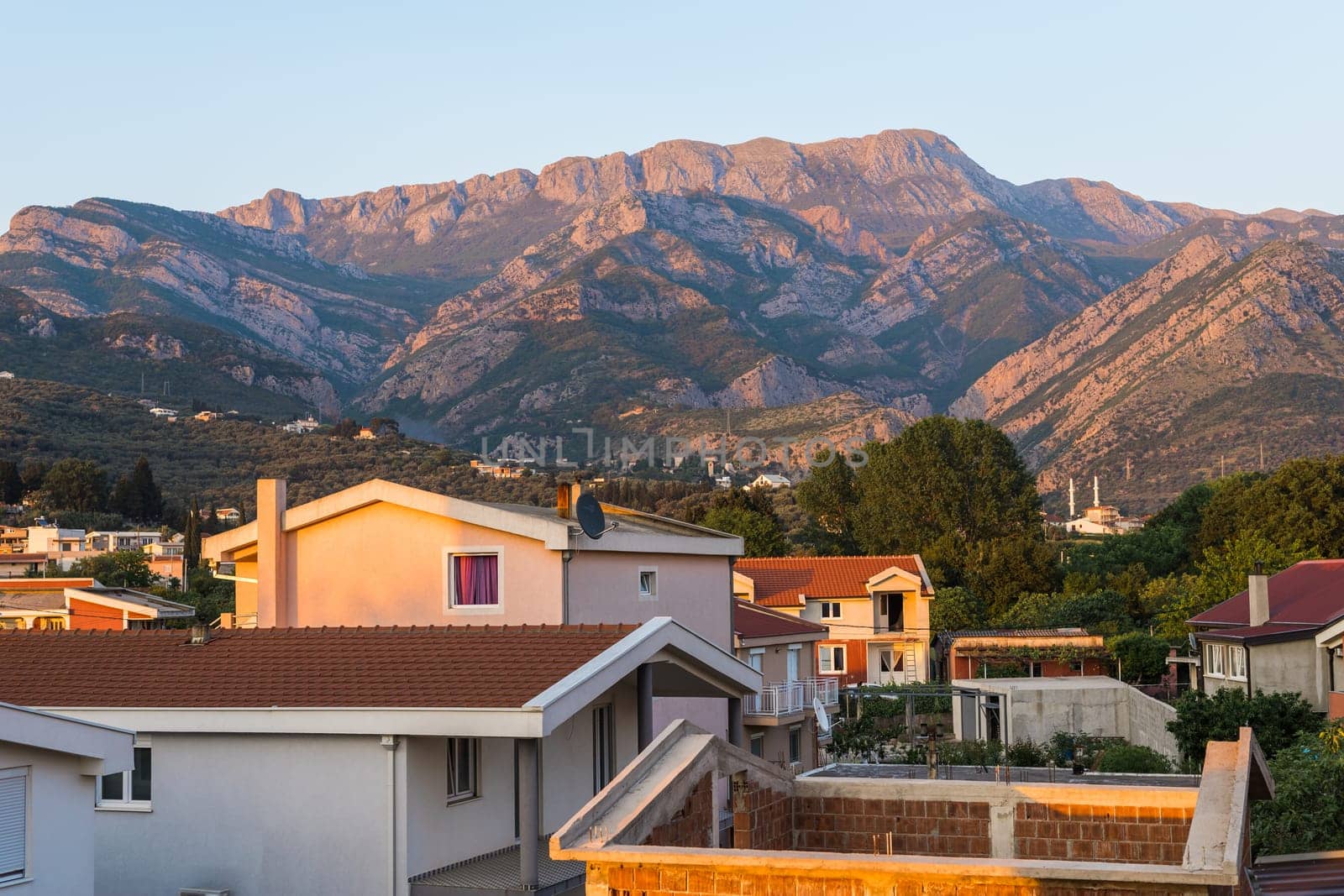 View of a small village with mountain houses on the mountain crest in Bar city Montenegro. Sunset by Satura86