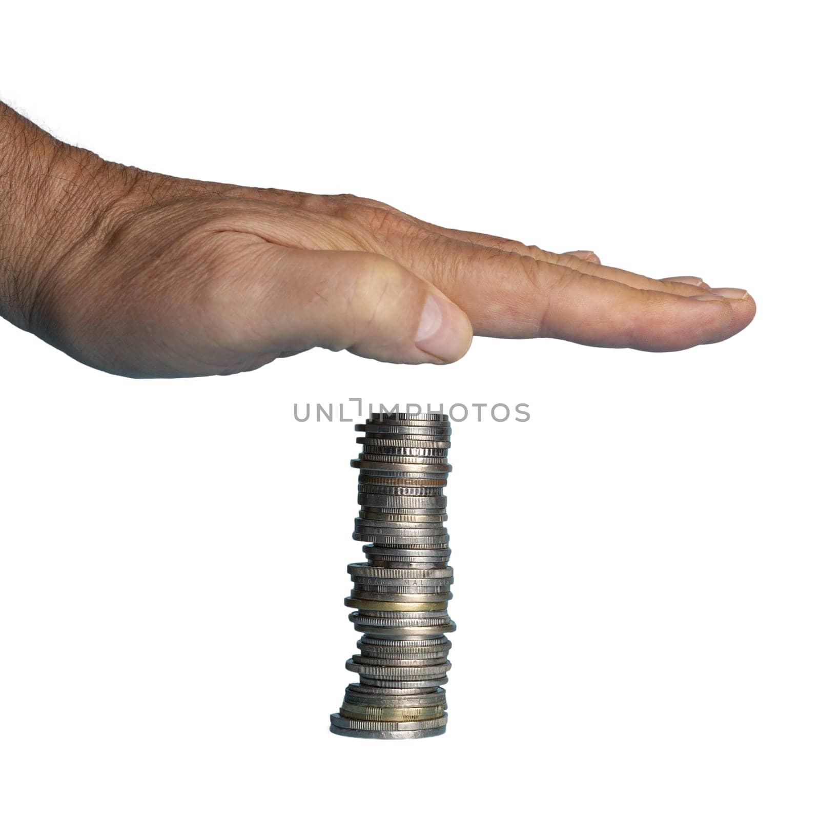 a hand over a hovering stack of coins. In concept of protection from the loss of currency value as a result of inflation