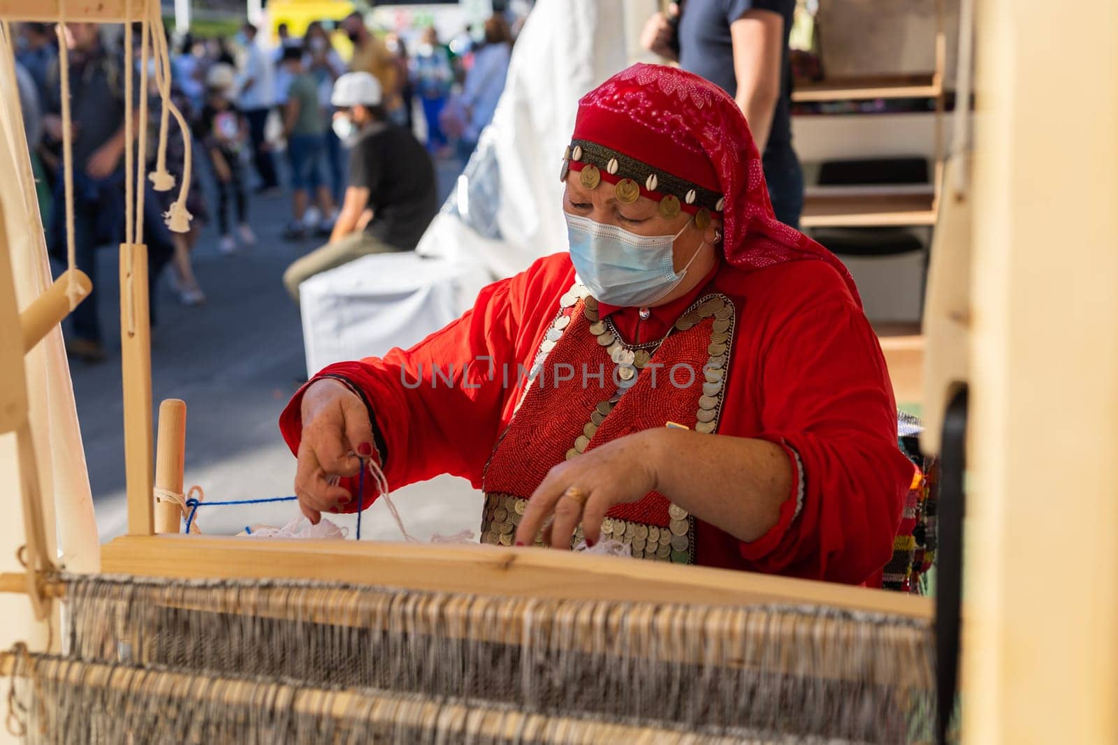 UFA, RUSSIA - JULY 10, 2021: Bashkir woman knitted national clothes during Folkloriada in Ufa by Satura86