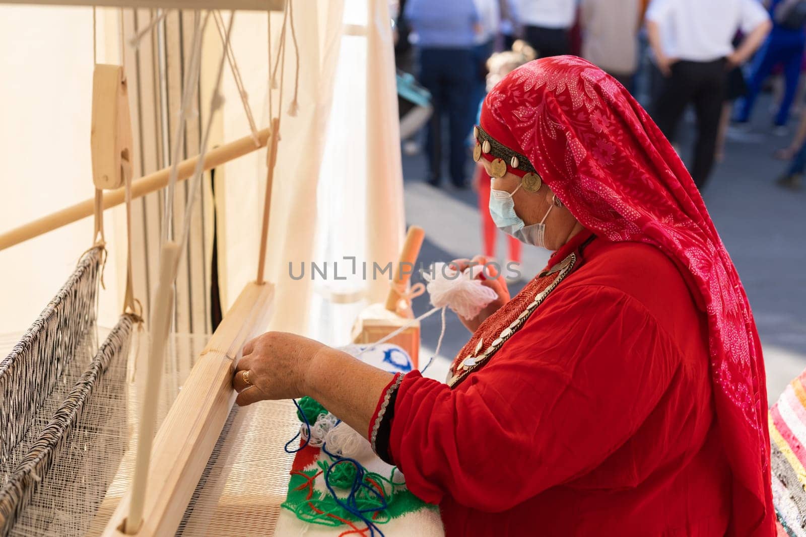 UFA, RUSSIA - JULY 10, 2021: Bashkir woman knitted national clothes during Folkloriada in Ufa by Satura86