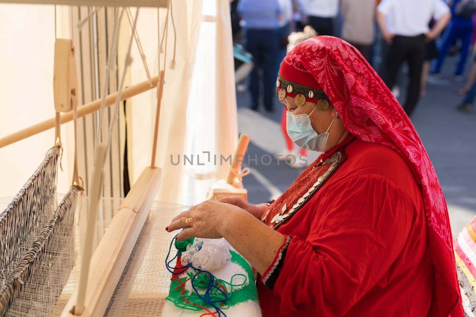 UFA, RUSSIA - JULY 10, 2021: Bashkir woman knitted national clothes during Folkloriada in Ufa by Satura86