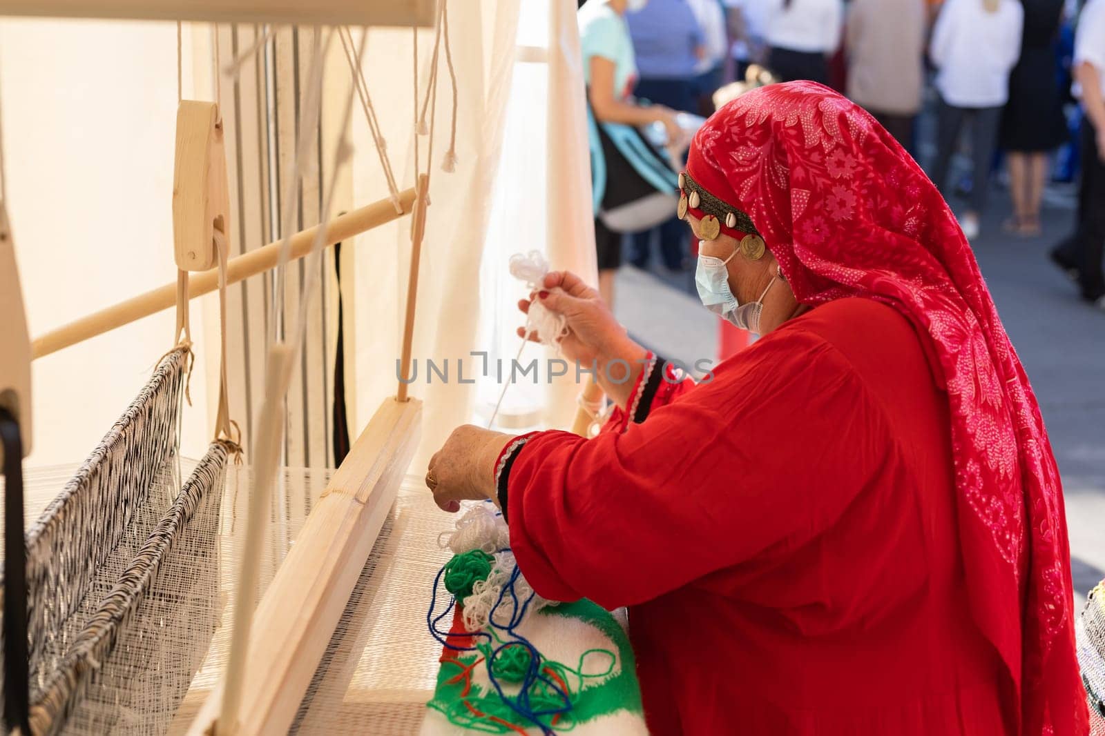 UFA, RUSSIA - JULY 10, 2021: Bashkir woman knitted national clothes during Folkloriada in Ufa by Satura86
