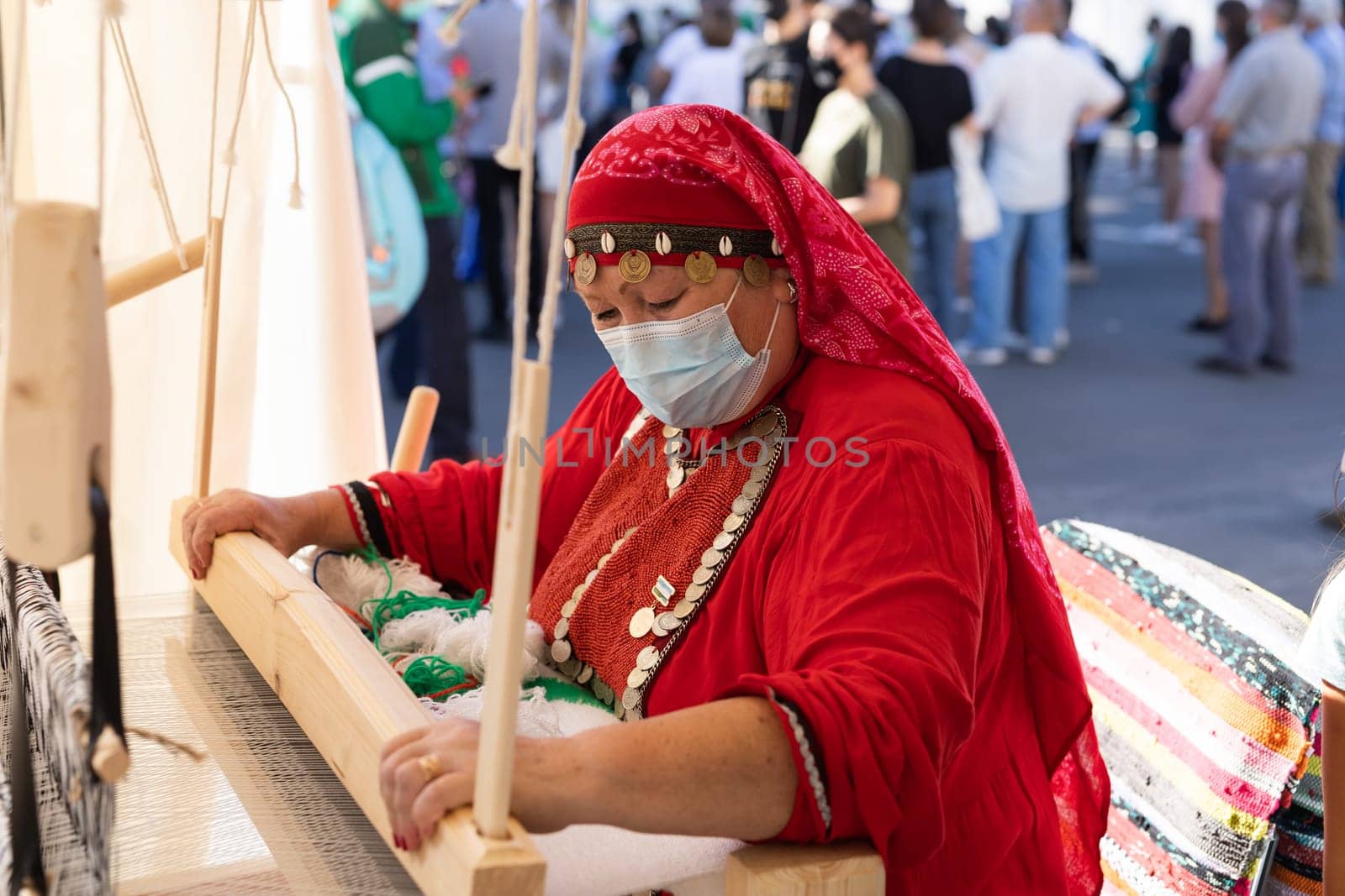 UFA, RUSSIA - JULY 10, 2021: Bashkir woman make carpet during Folkloriada by Satura86