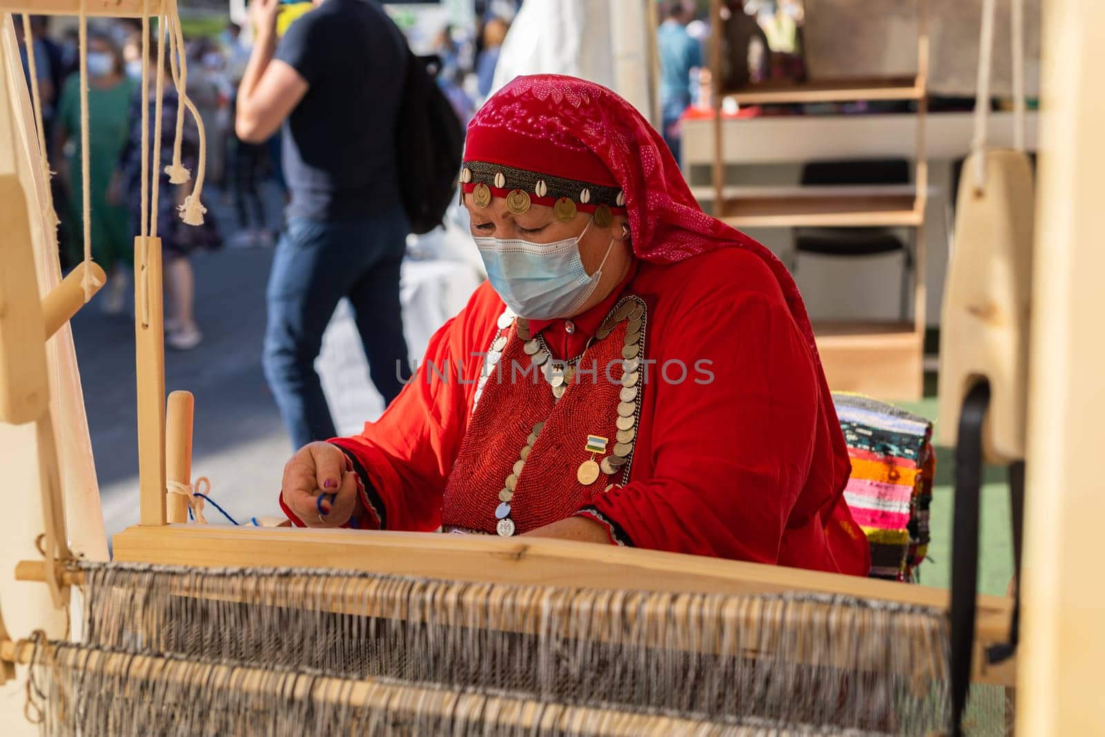 UFA, RUSSIA - JULY 10, 2021: Bashkir woman make carpet during Folkloriada by Satura86