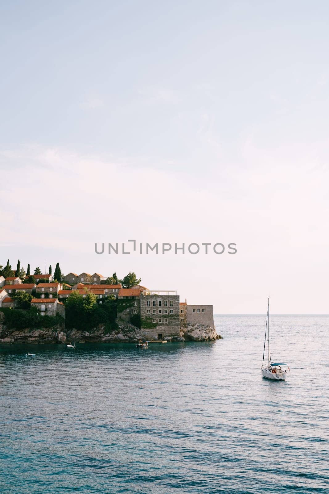 Sailing yacht sails to the island of Sveti Stefan. Montenegro. High quality photo