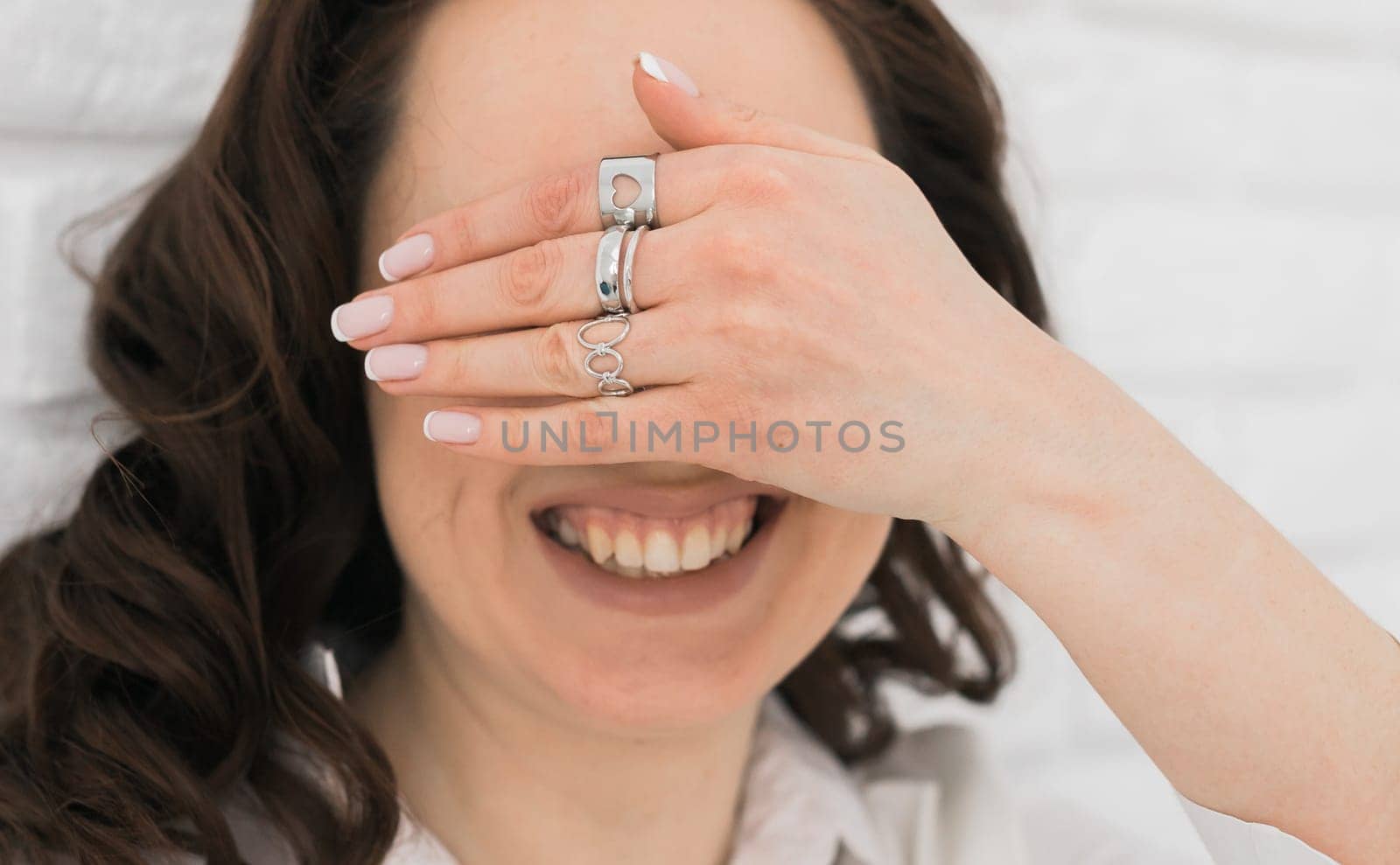 Women Jewelry concept. Woman's hands close up wearing rings and necklace modern accessories elegant lifestyle. Funny girl.