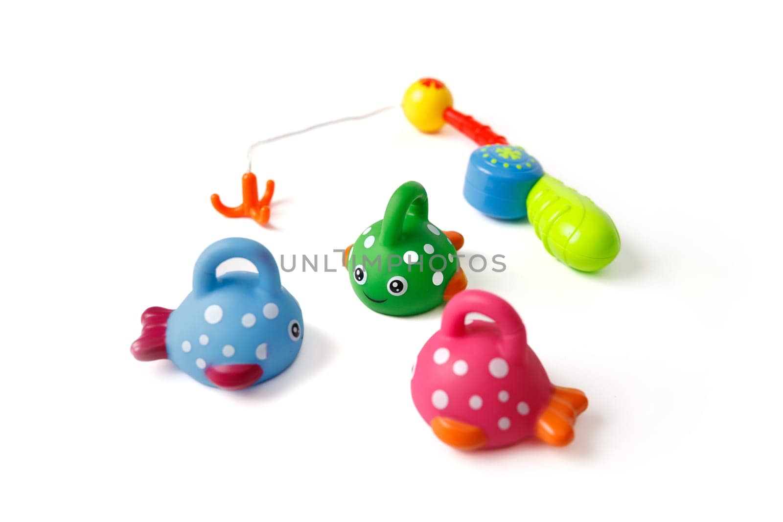 Children's set of fishing toys with cute fish and fishing rod on a white background.