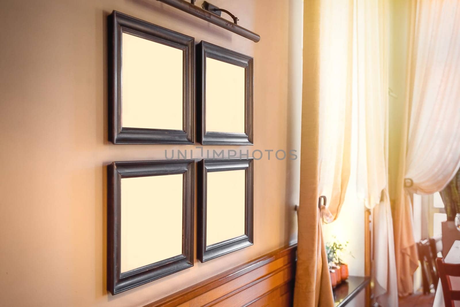Template with 4 frames for paintings or photographs in the interior next to the window on a sunny day by Rom4ek
