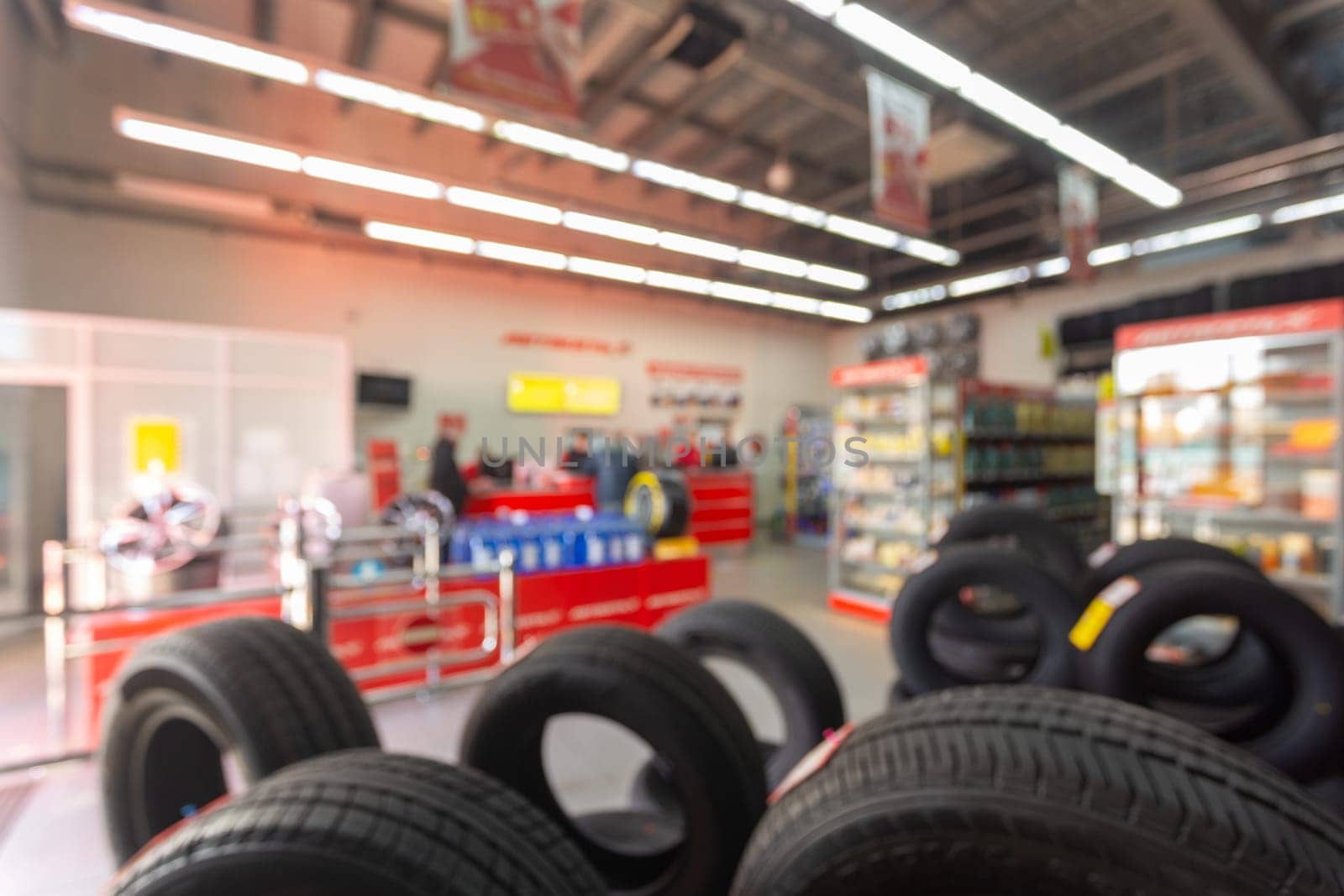 Blurred image rows of brand new tires for sale at retail store. by BY-_-BY