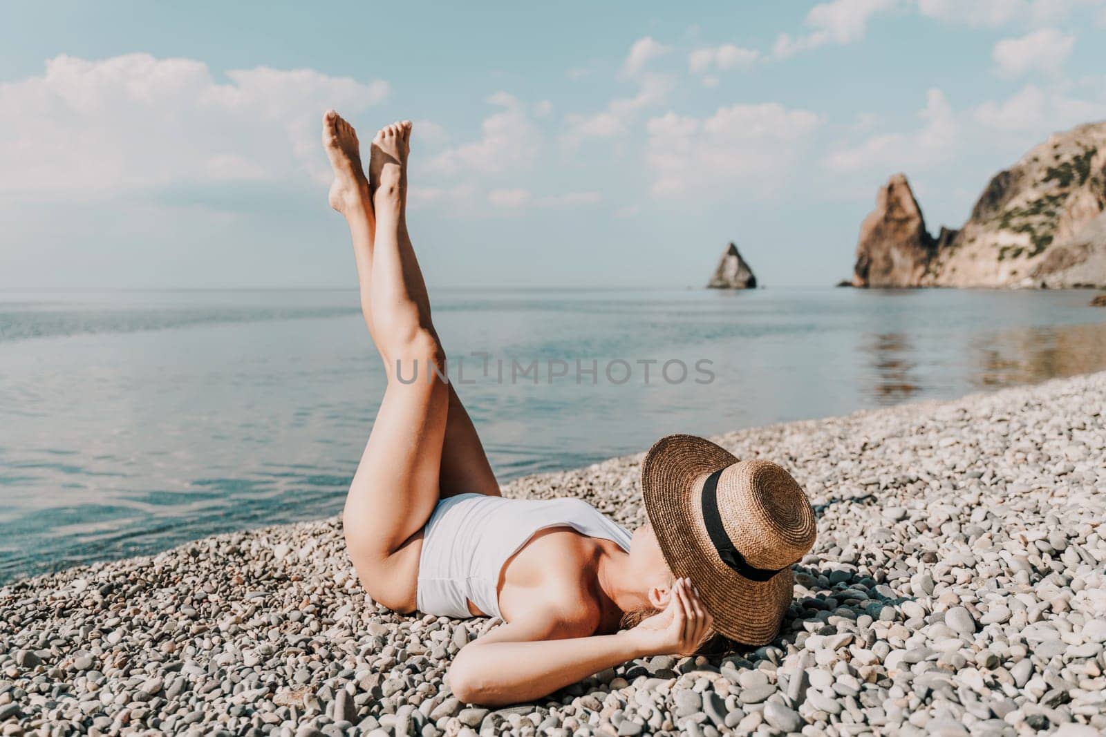Woman white bikini beach tan. Happy woman in swimwear and hat on vacation. Summer travel holidays vacation on the sea.
