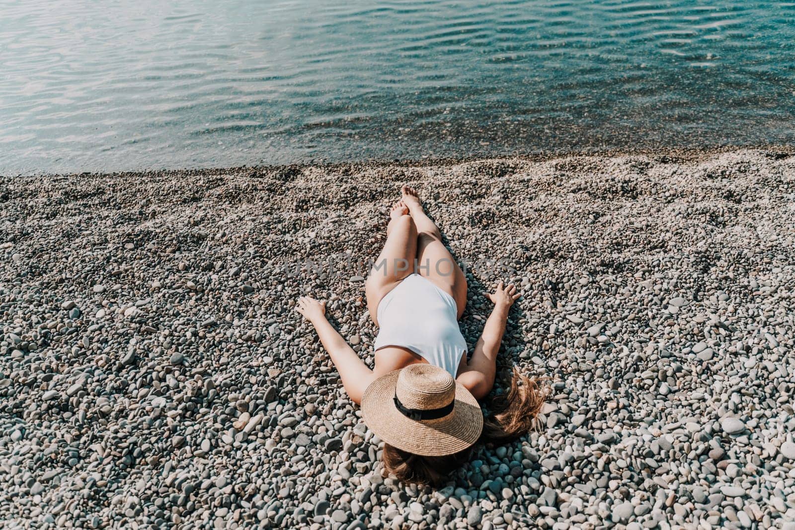Woman white bikini beach tan. Happy woman in swimwear and hat on vacation. Summer travel holidays vacation on the sea by Matiunina