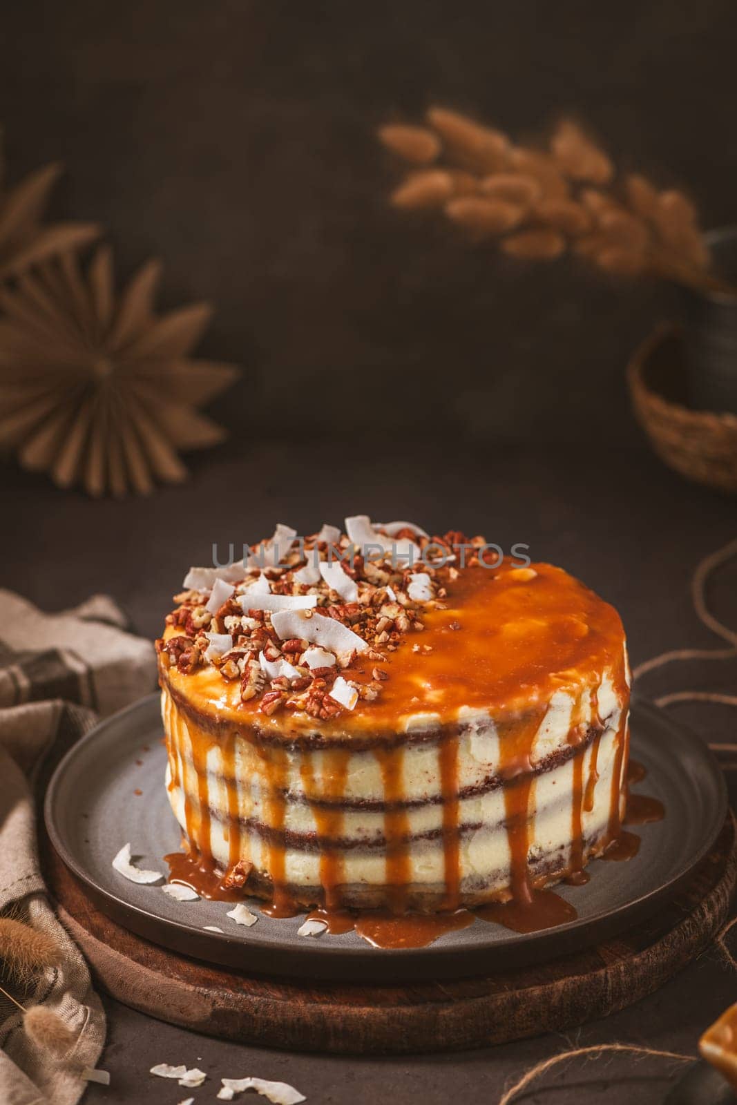 Delicious caramel cake with small pieces of pecan nuts and coconut shavings.