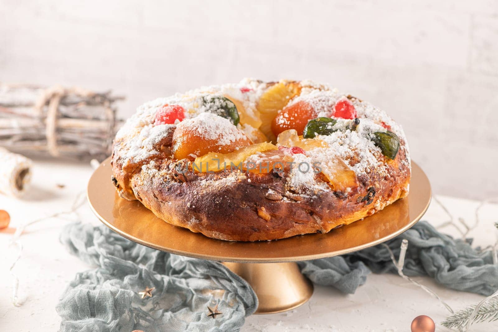 Bolo do Rei or King's Cake, Made for Christmas, Carnavale or Mardi Gras with Christmas season elements in Background.