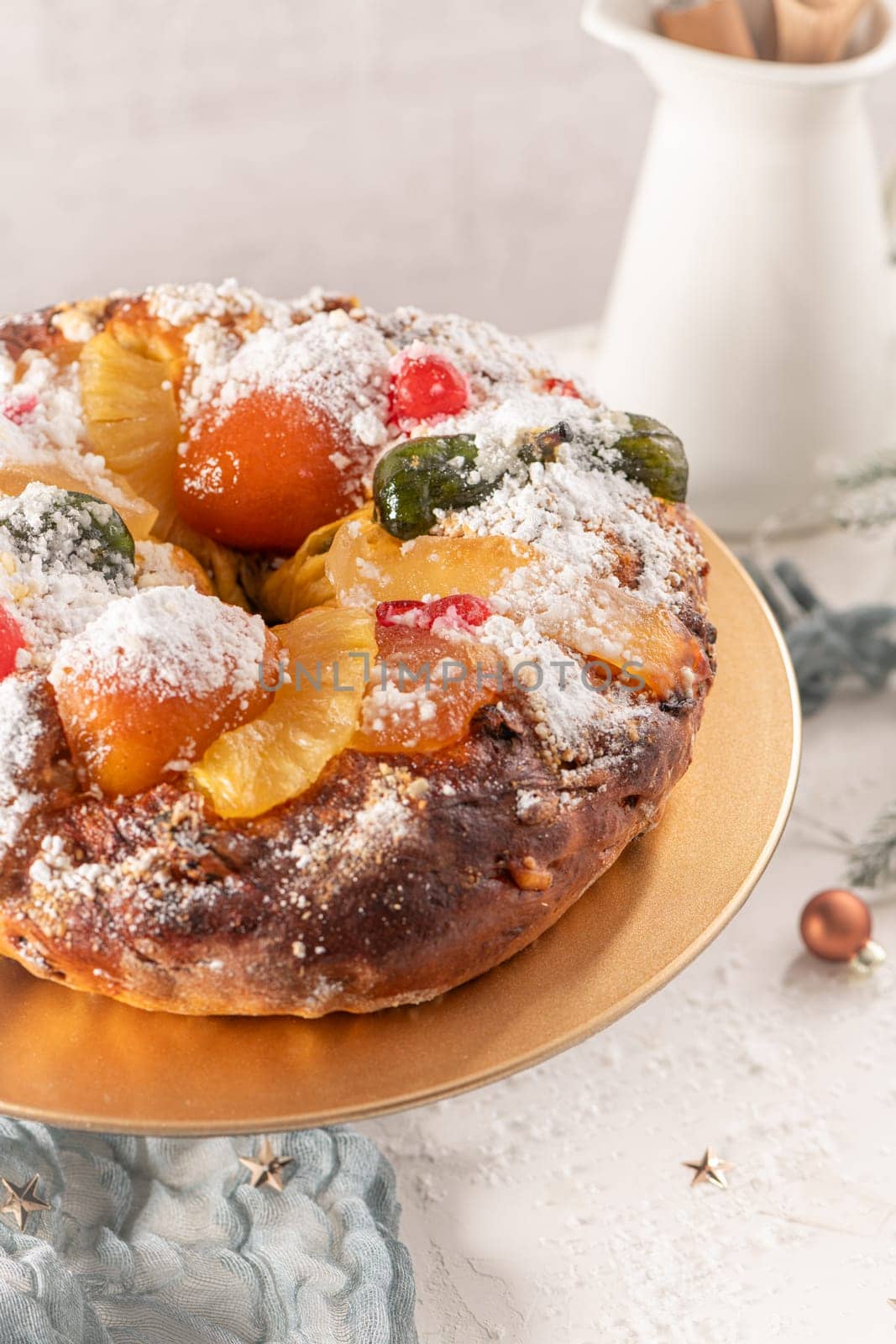 Bolo do Rei or King's Cake, Made for Christmas, Carnavale or Mardi Gras with Christmas season elements in Background.