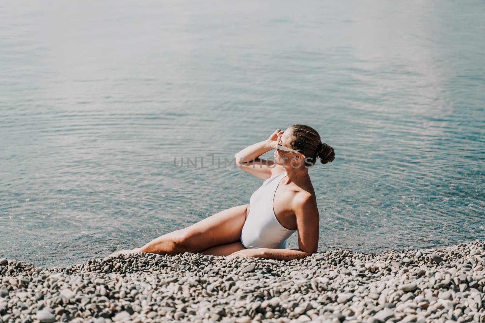 Woman white bikini beach tan. Happy woman in swimwear on vacation. Summer travel holidays vacation on the sea.