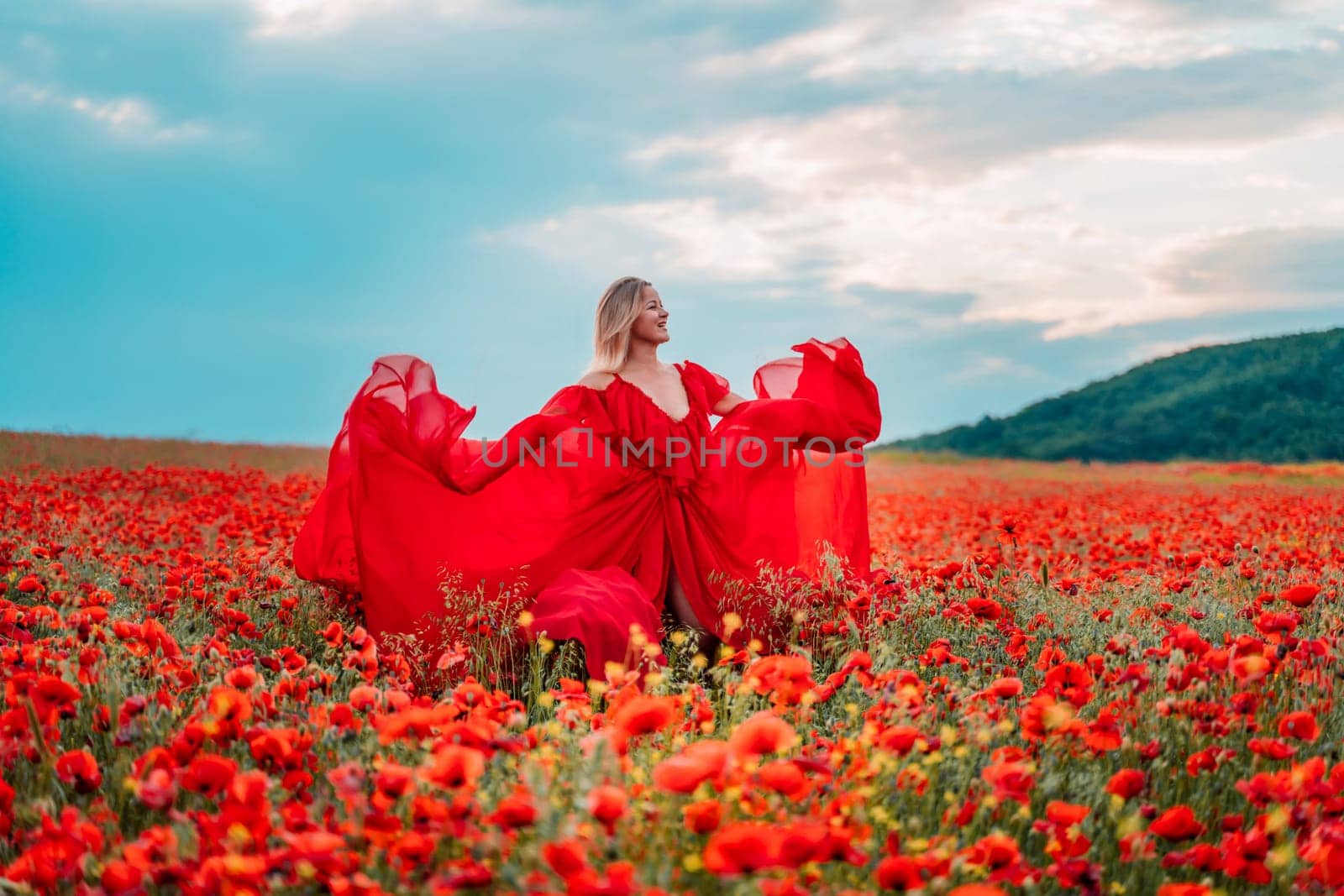 Woman poppy field red dress. Happy woman in a long red dress in a beautiful large poppy field. Blond stands with her back posing on a large field of red poppies by Matiunina