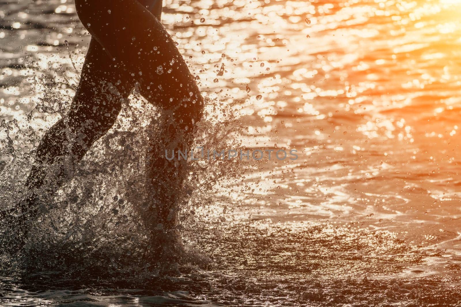 Running woman on a summer beach. A woman jogging on the beach at sunrise, with the soft light of the morning sun illuminating the sand and sea, evoking a sense of renewal, energy and health. by panophotograph