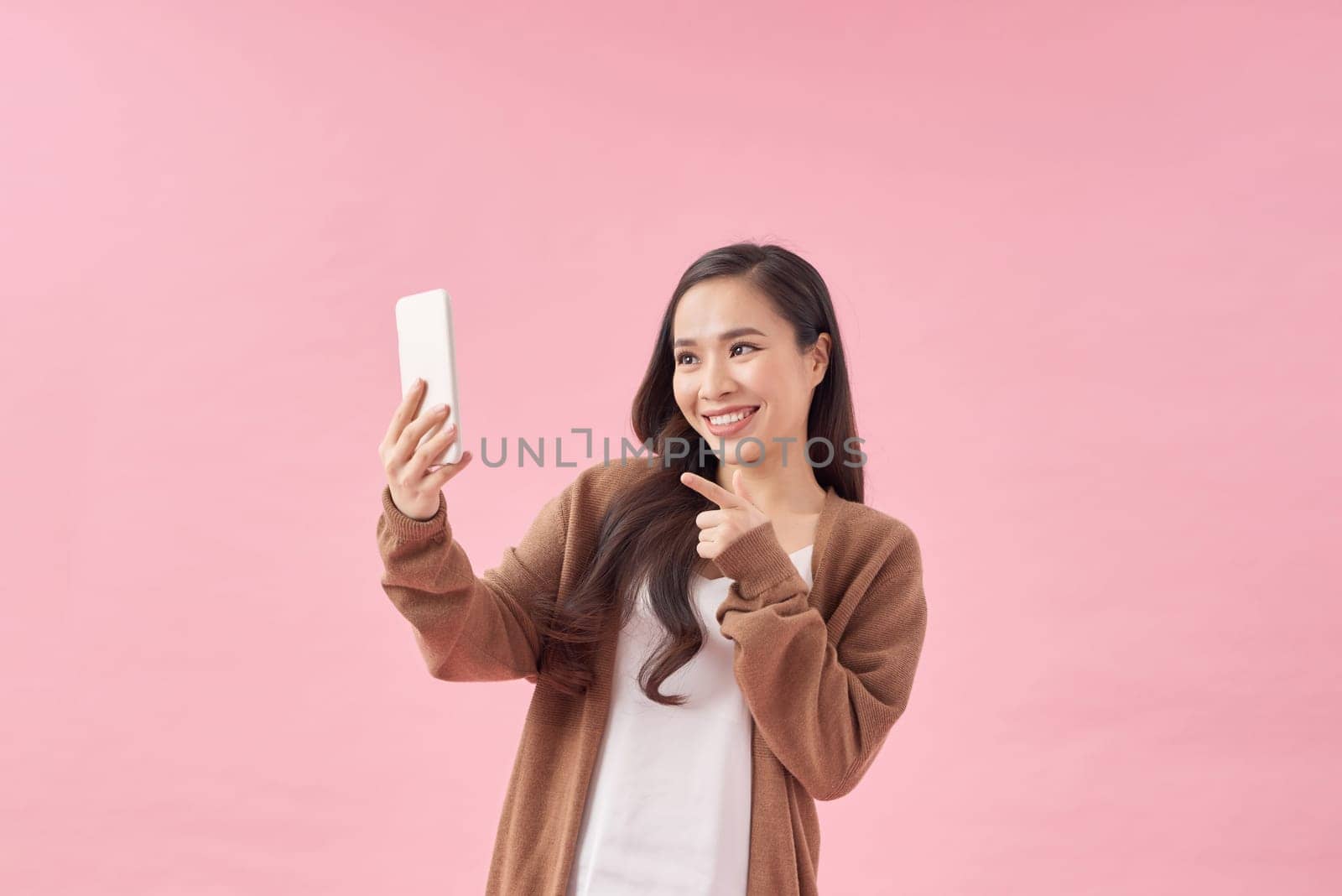 Portrait of beautiful asian women Use the mobile phone happily on a white background