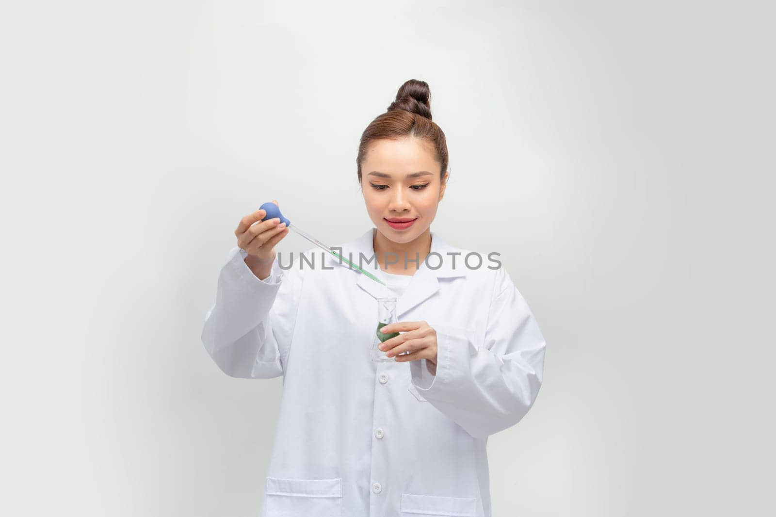 Good looking scientist looking at a test tube in a lab
