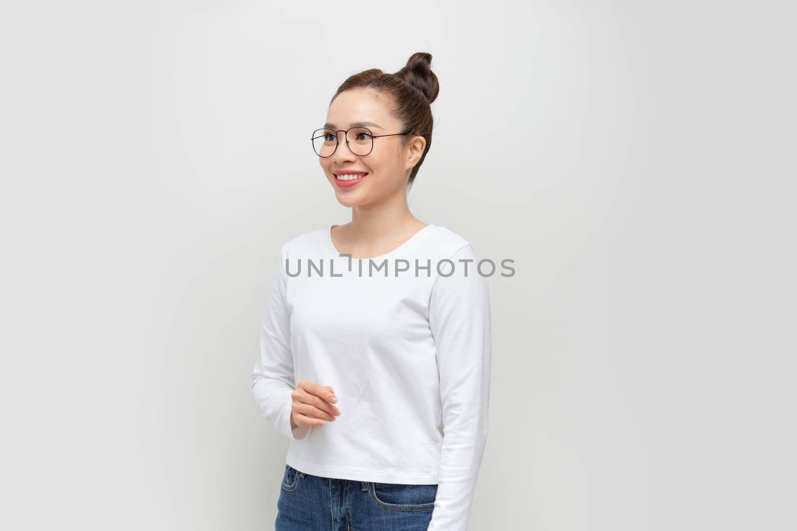 Beautiful young woman smiling against white background. by makidotvn