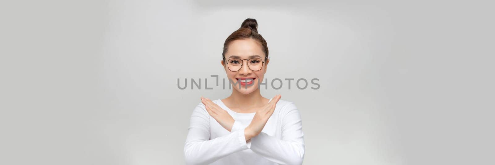 Cheerful emotional young asian female  having fun laughing at joke crossing hands, asking to stop. 