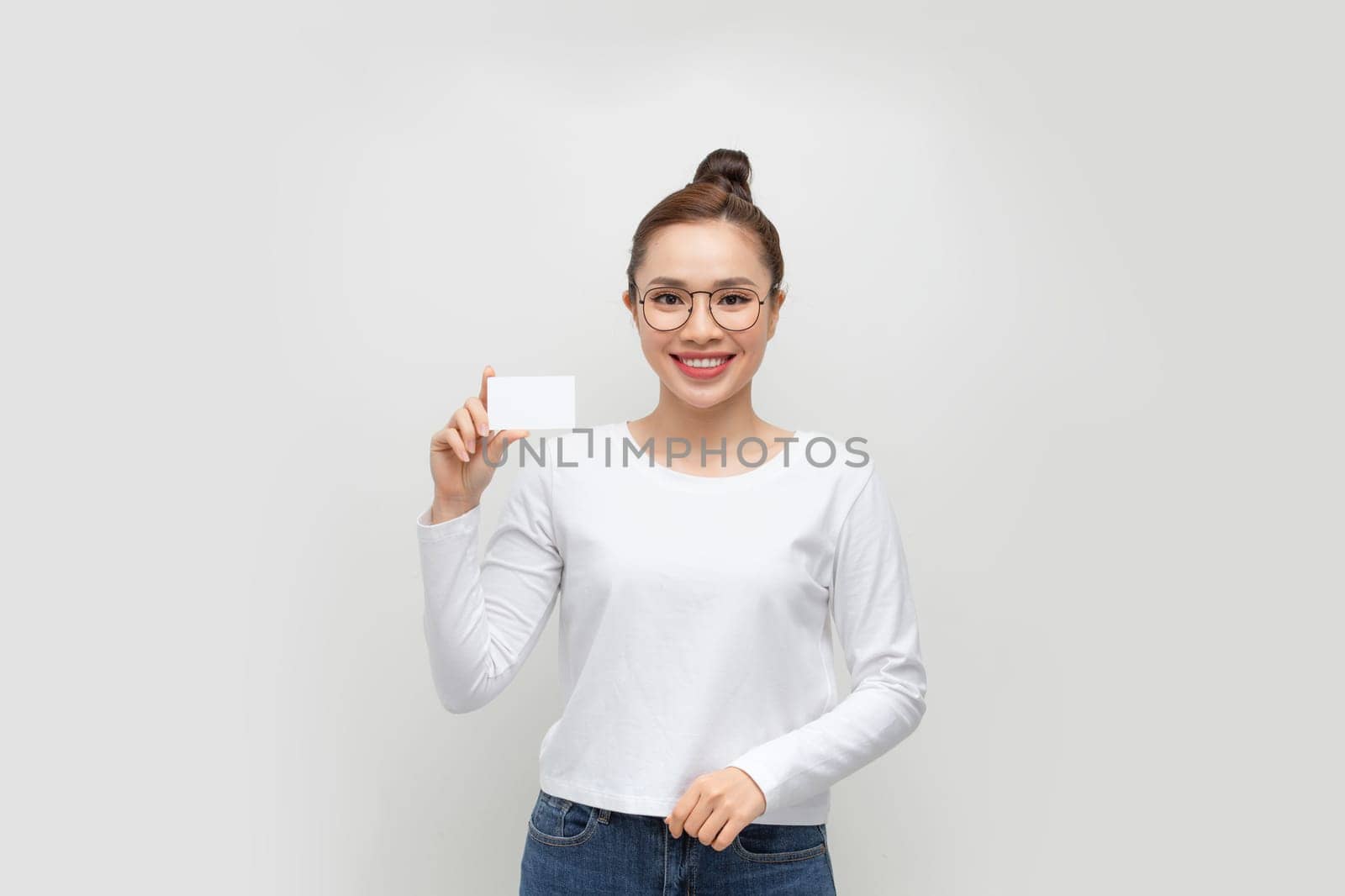 Happy asian woman showing blank credit card.  by makidotvn