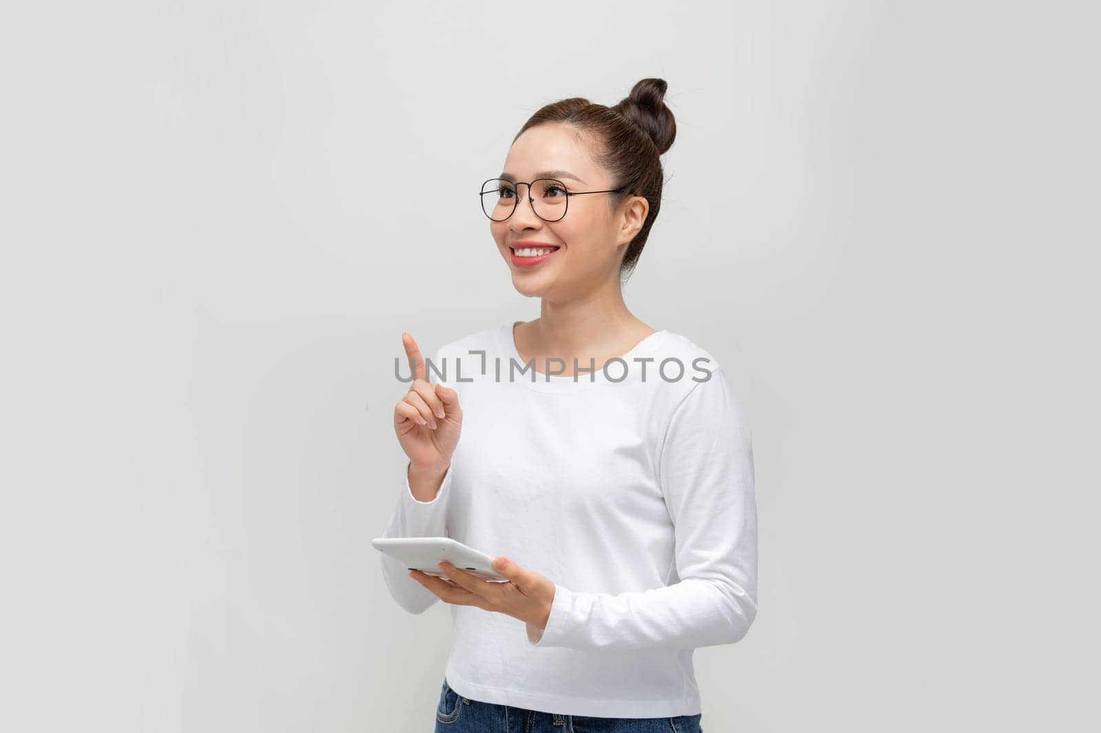 Young woman with calculator and raised index finger on white background by makidotvn
