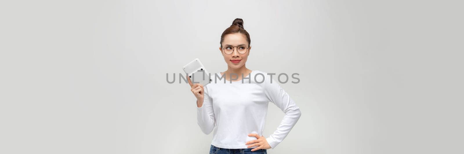 Happy young businesswoman showing calculator