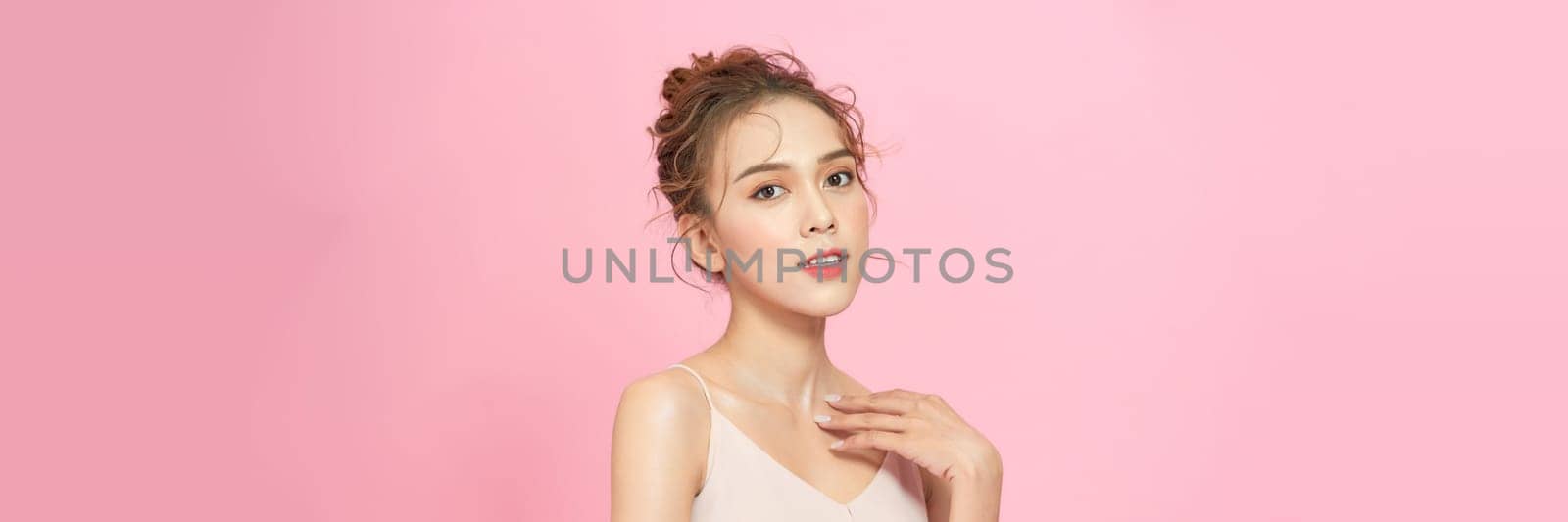 Beautiful young Asian woman on pink pastel background, summer vacation concept