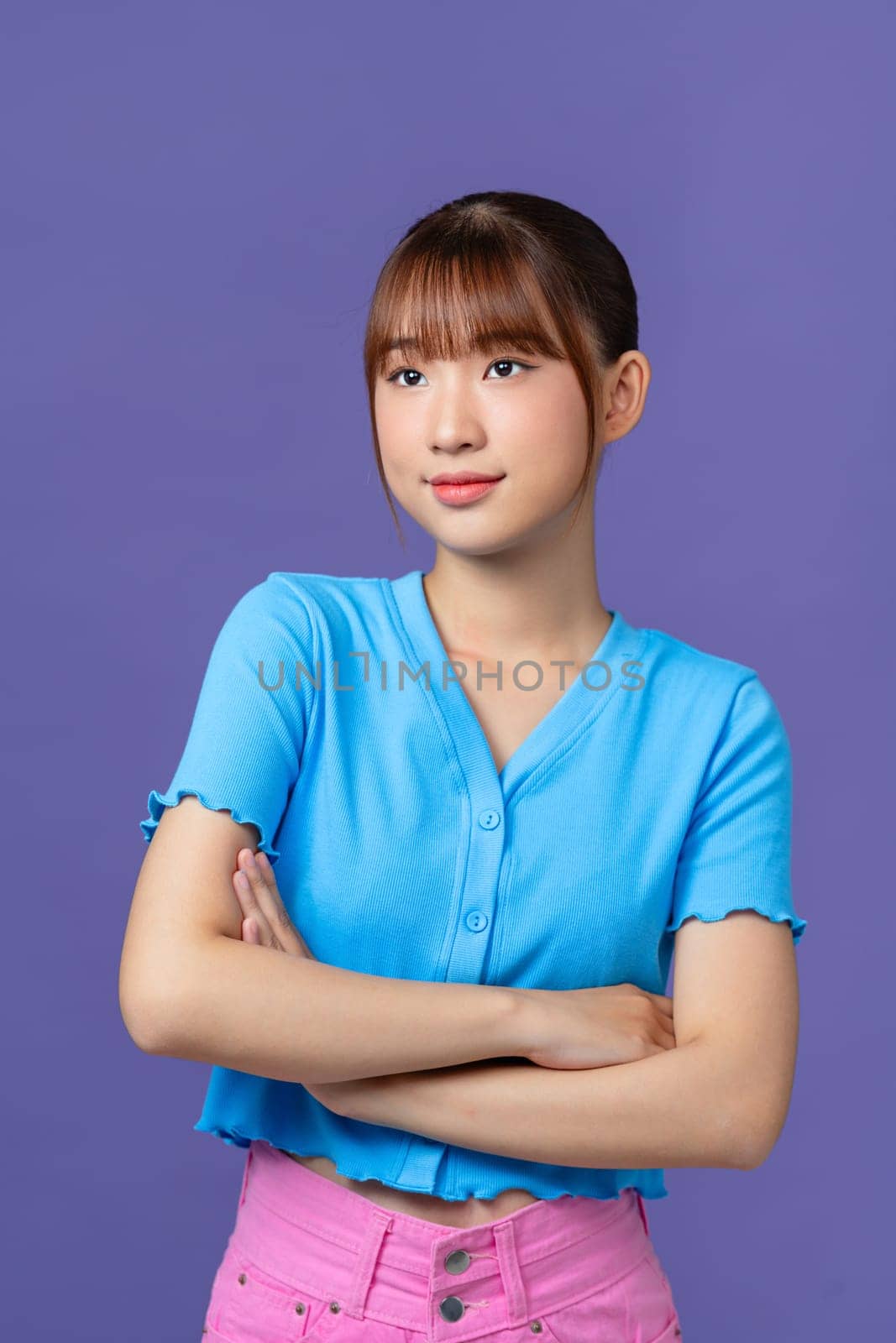 Image of a happy cheerful young pretty woman posing isolated over purple background looking aside. by makidotvn