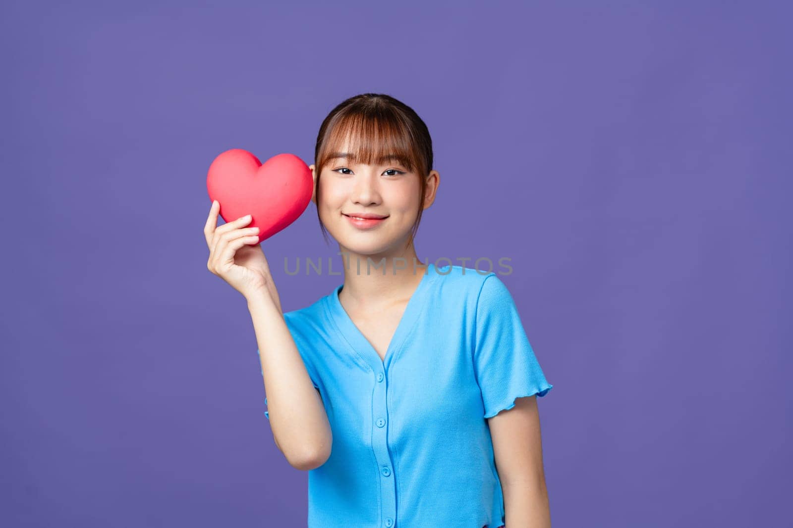 Asian woman with red heart on purple background by makidotvn
