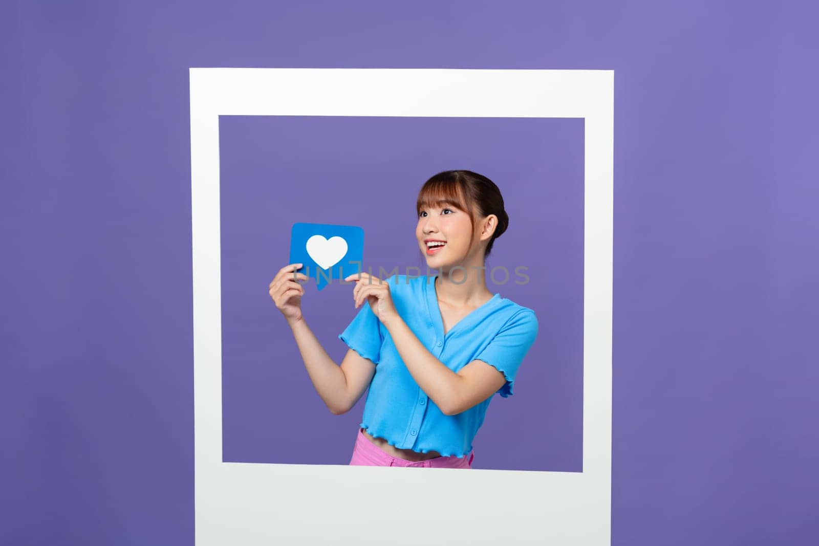 Positive astonished person hands hold Like icon in paper album card isolated on purple background