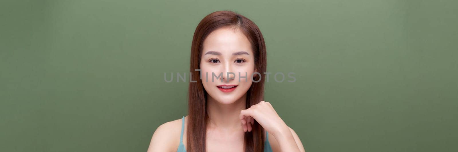 Portrait of young woman with perfect skin clean on green banner background by makidotvn