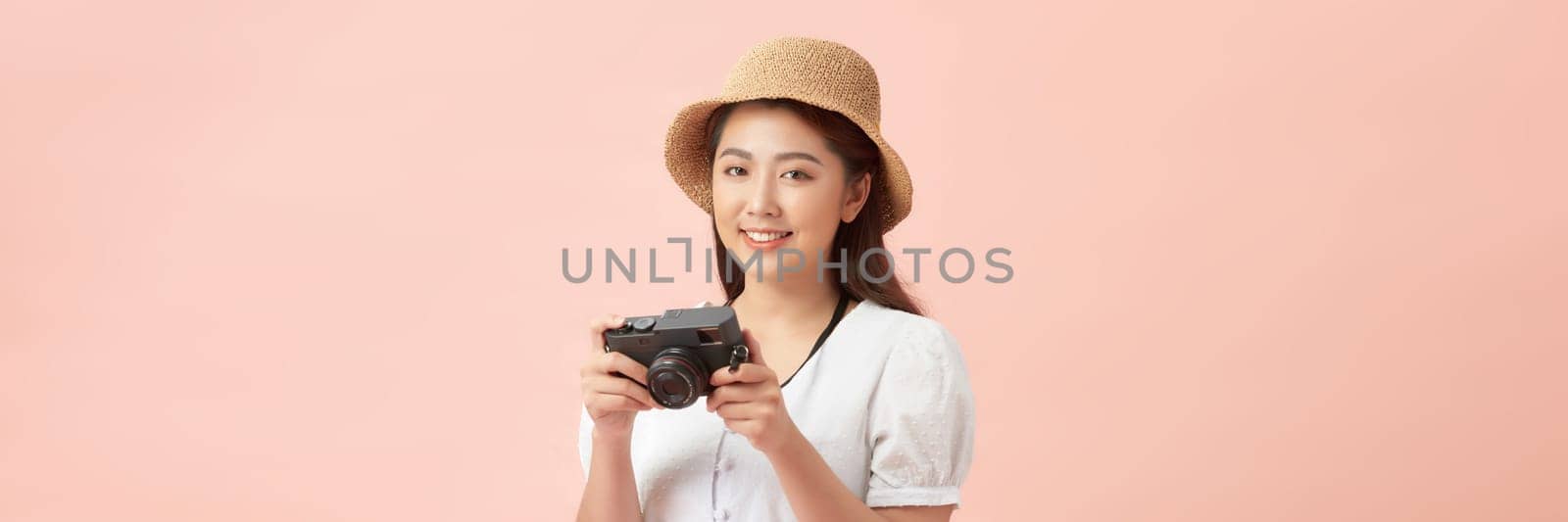 Tourist woman wearing hat with photo camera isolated on banner background