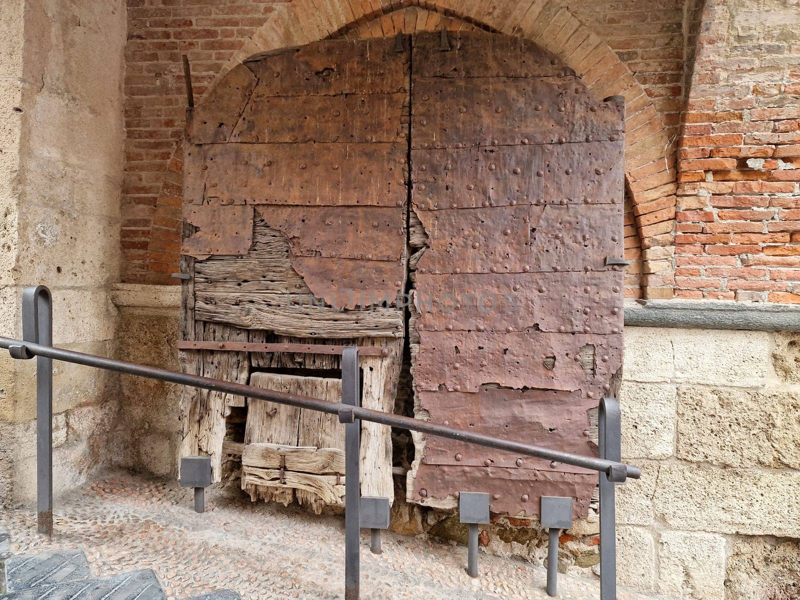 wooden medieval door of noli medieval village liguria italy by AndreaIzzotti