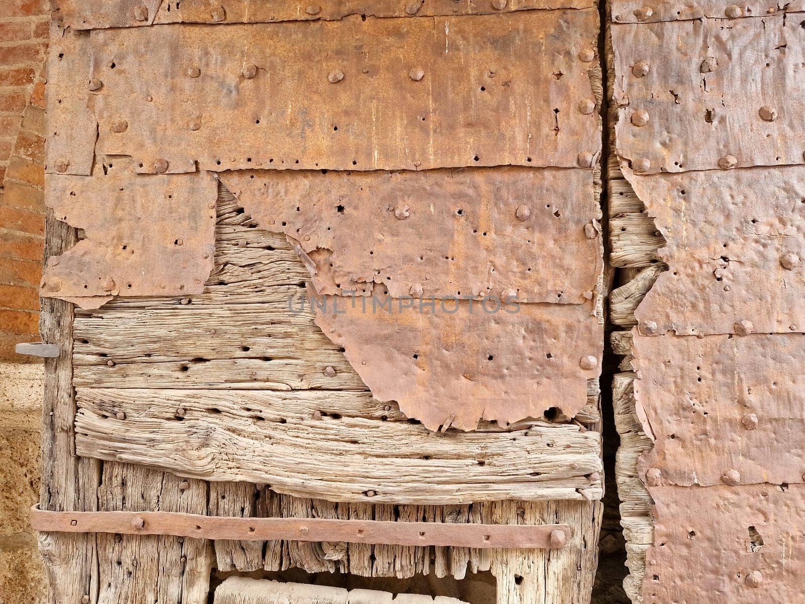 wooden medieval door of noli medieval village liguria italy by AndreaIzzotti