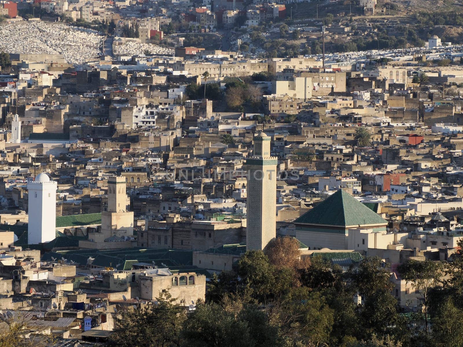 detail of mosque tower Aerial view panorama of the Fez el Bali medina Morocco. Fes el Bali was founded as the capital of the Idrisid dynasty between 789 and 808 AD. by AndreaIzzotti