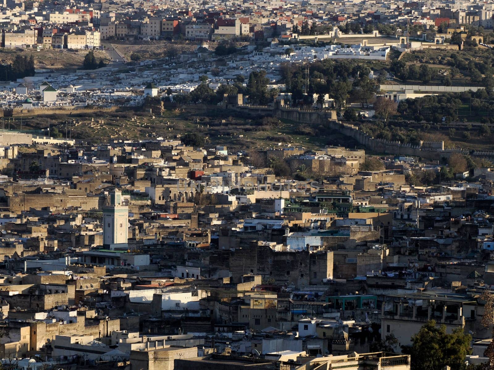 detail of mosque tower Aerial view panorama of the Fez el Bali medina Morocco. Fes el Bali was founded as the capital of the Idrisid dynasty between 789 and 808 AD. by AndreaIzzotti