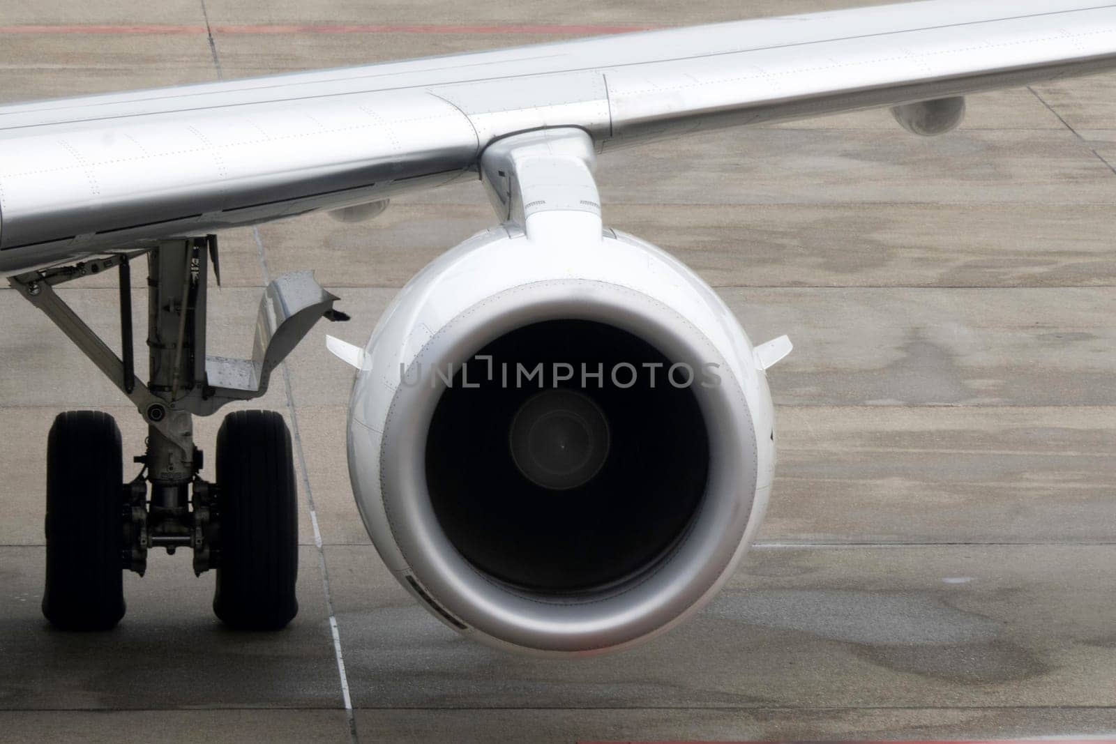 engine detail of airplane while parking at the terminal by AndreaIzzotti