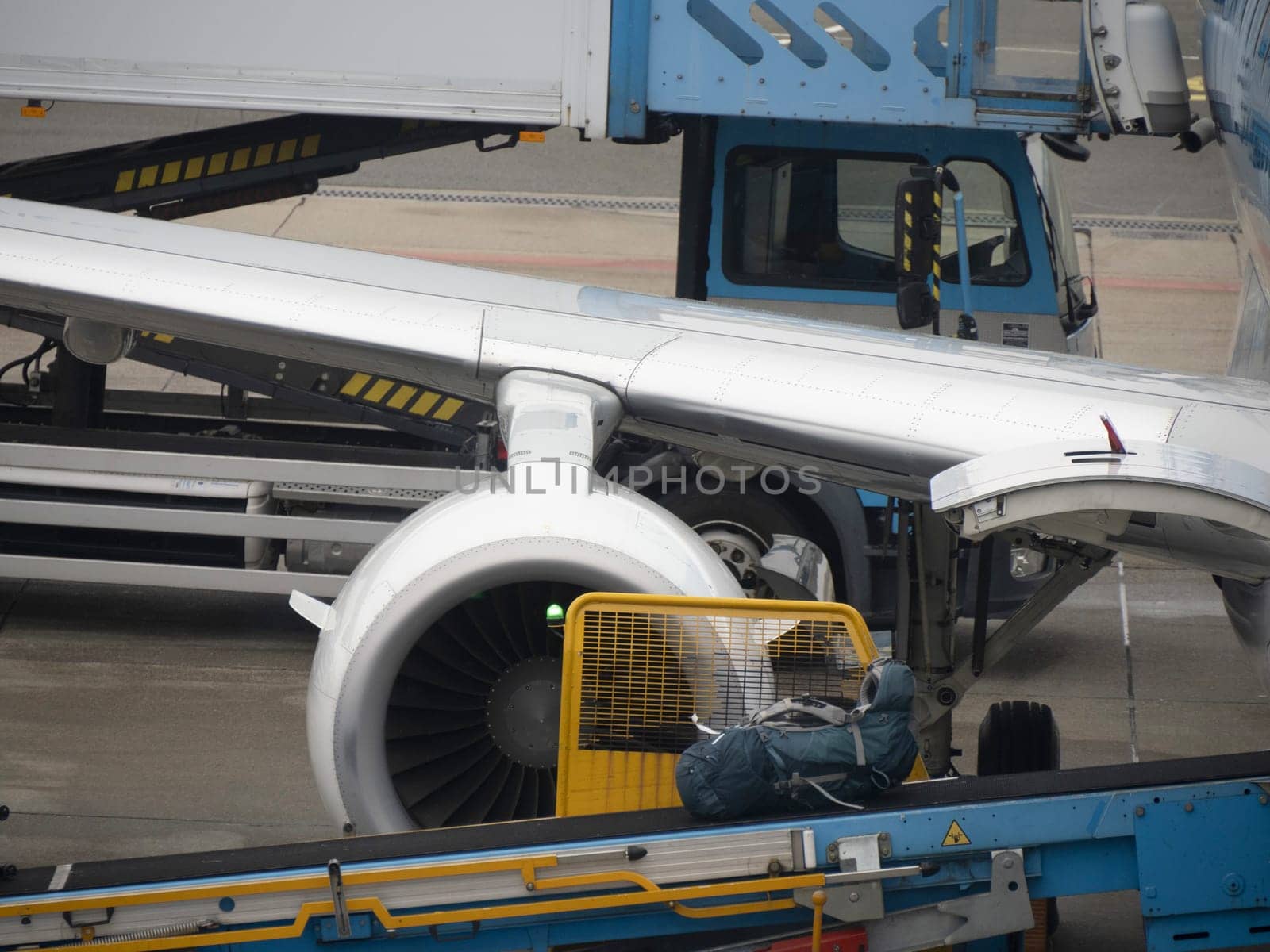 Detail of baggage uploading to airplane while parking at the terminal